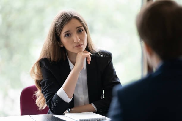 Engaged young recruiter, recruit agent talking to job candidate on interview. Client consulting manager, banker lawyer in office. Business woman, broker, advisor listening to customer on meeting